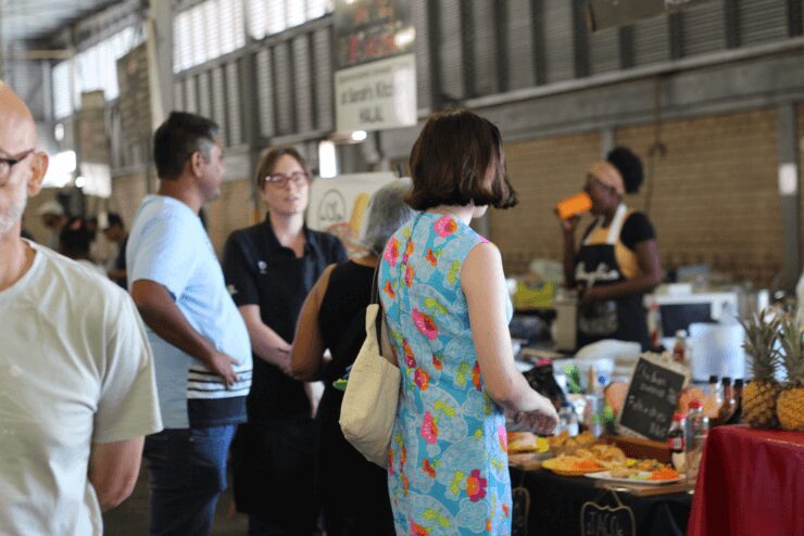 Woman browsing food selection at Rosebank Sunday Market 