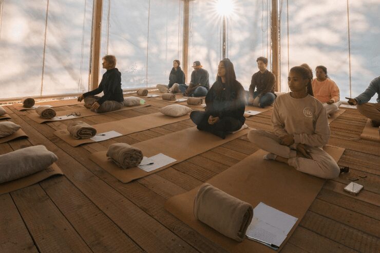 group of people sitting in studio journaling and meditating at Farmhouse58 wellness retreat