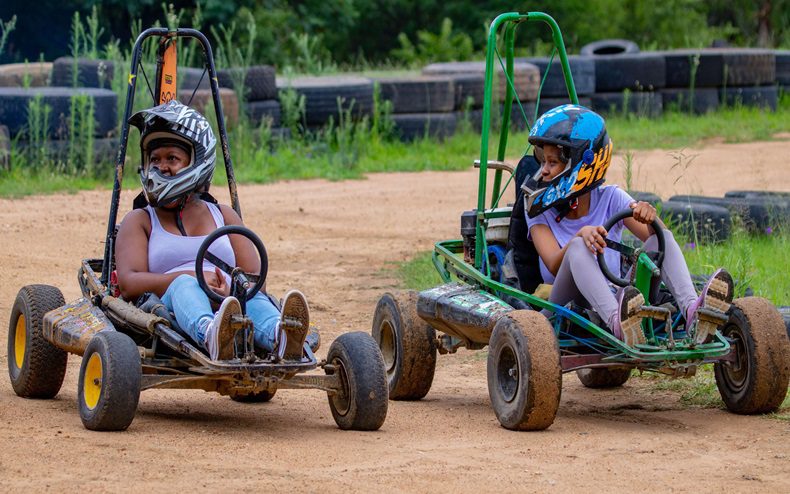 Two women Go-Karting on a Ground Zero dirt track