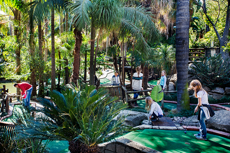 Kids playing golf on the Adventure Golf course