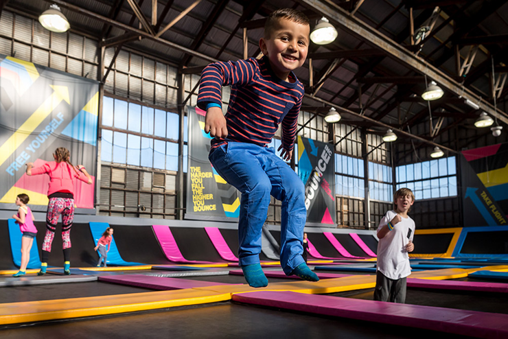 A child jumping on a trampoline at BOUNCE