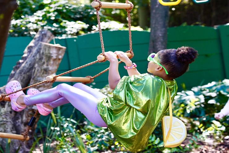 A child climbing up a treehouse ladder