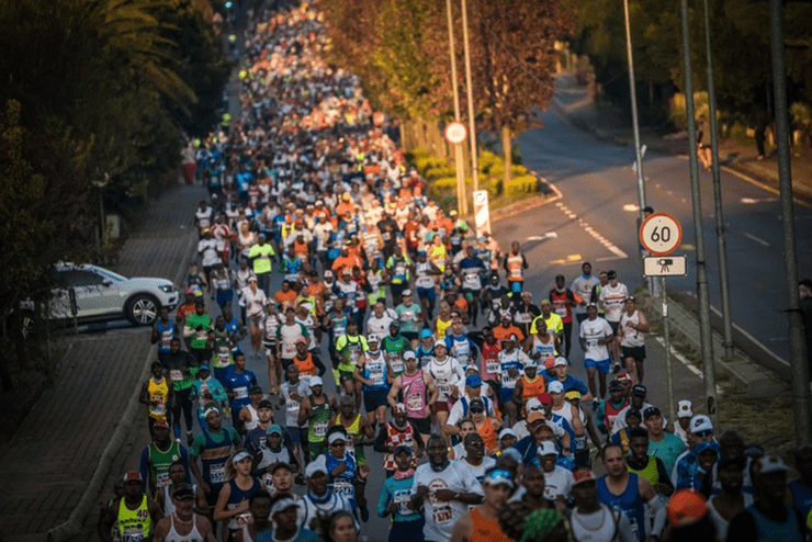 An aerial shot of a large group of runners running slightly uphill