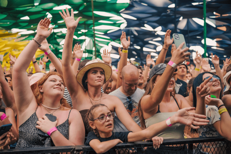 A crowd raises their hands to music at the Park Acoustics May Event