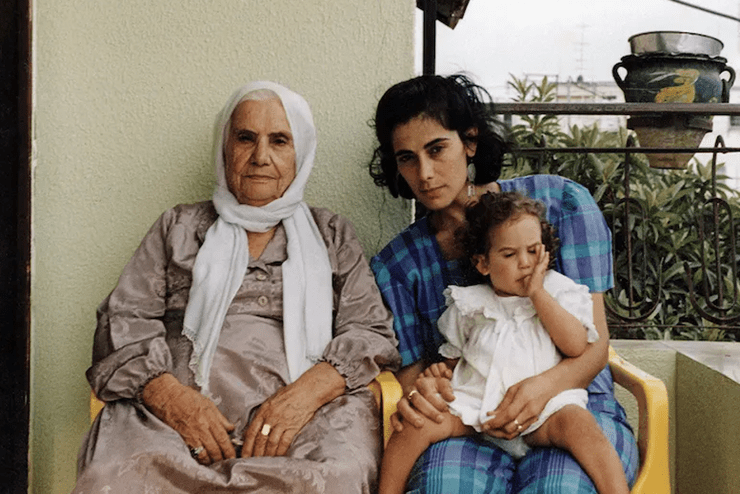 A vintage image of actress Hiam Abbass holding a baby along side an older female family member - Events in Johannesburg