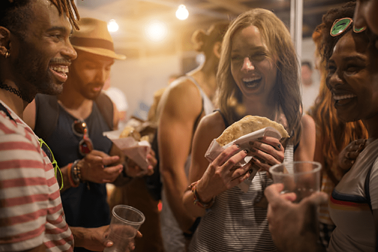 Attendees eating and laughing at the Mzansi Food and Drink Show