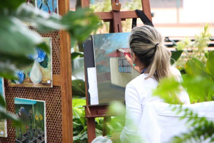 A woman painting outdoors