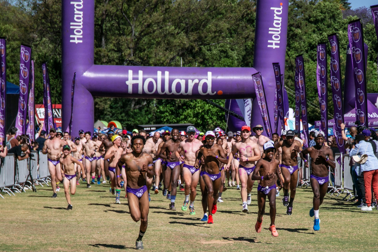 Men running in purple speedos for the Hollard Daredevil Run